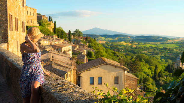 Montepulciano, Tuscany, Italy, Girl looks at the landscape of the city and countryside from the balcony