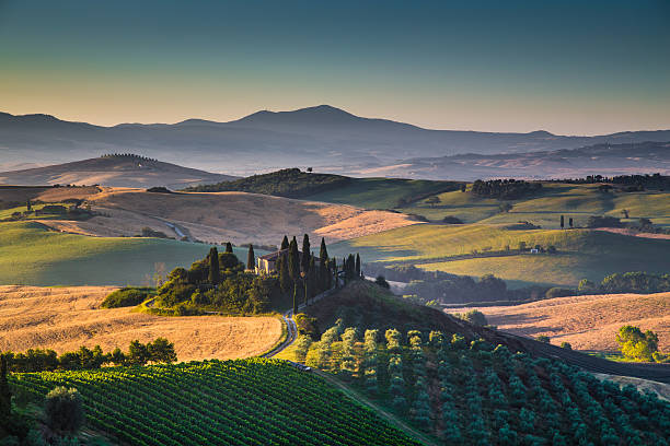 Scenic Tuscany landscape with rolling hills and valleys in golden morning light, Val d'Orcia, Italy.